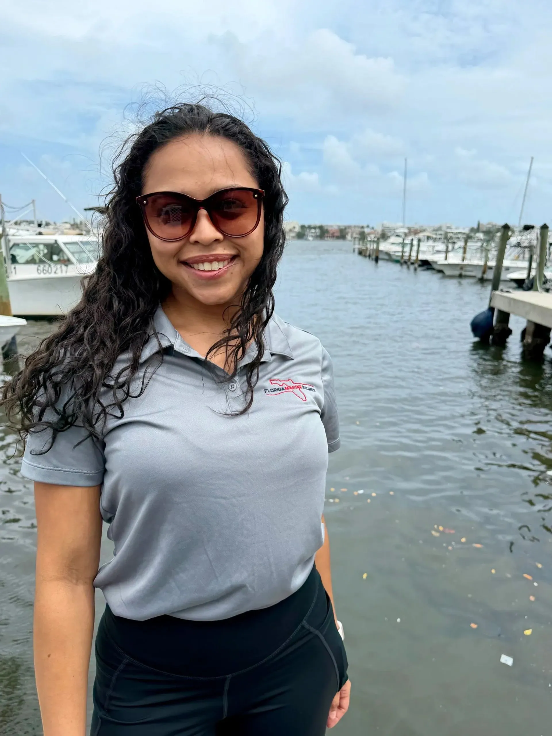 Danelly S., Office Manager at Florida Marine Builders, photographed at the marina